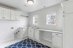 Laundry room with quartz countertops.