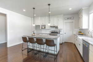 Granite counter tops, gas range, and farmhouse sink.