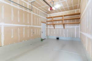 3rd car garage with side exit door.