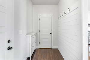 Mudroom with garage door to the left and coat closet straight ahead.