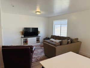 Living area with wood finished floors and baseboards