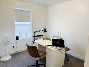 Home office featuring carpet and baseboards