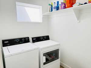 Washroom featuring washer and dryer and laundry area