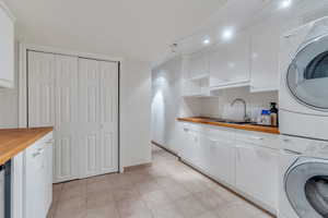 Large laundry room has folding table and sink