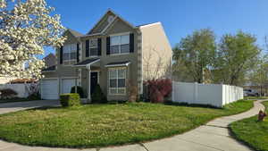 View of front facade with fence, stucco siding, a garage, and concrete driveway