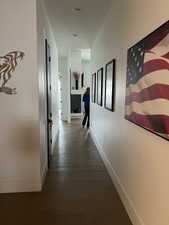 Corridor with baseboards and wood finished floors