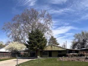 View of front of house featuring concrete driveway, a fenced front yard,