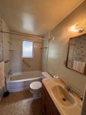 Full bath with bathing tub / shower combination, vanity, and toilet