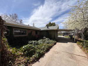 View of side of property featuring carport