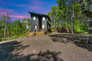 View of front of home with board and batten siding and a deck