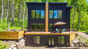 Back of property with french doors and a wooden deck