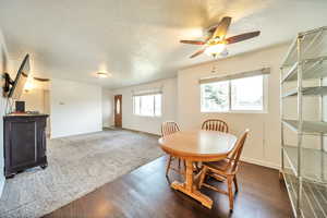 Dining space with ceiling fan and laminate floors