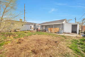 Fully fenced backyard with extra storage and covered patio area