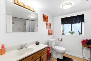Bathroom with a single vanity featuring a wood-finish cabinet and a white countertop