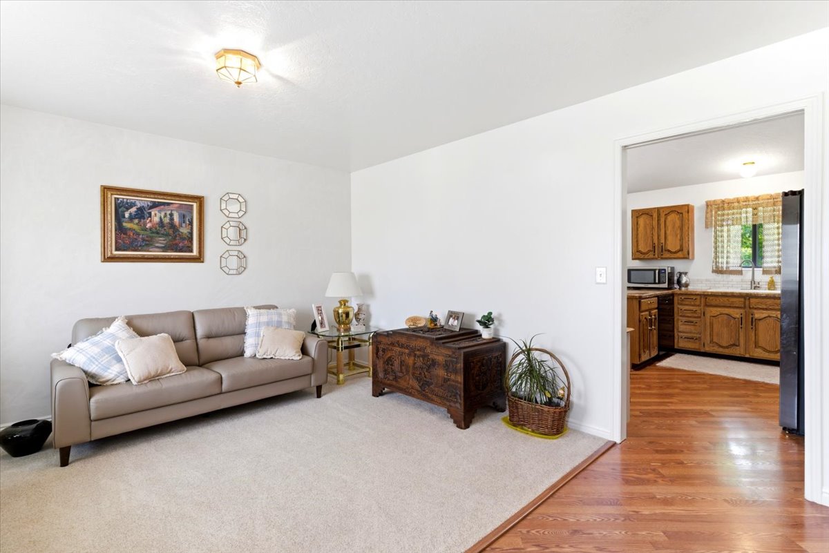 Bright interior space featuring light-colored carpeting, white wall finishes, and a flush-mount ceiling light fixture