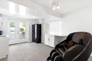 Light-filled space featuring French doors, white cabinetry, a built-in countertop, and track lighting