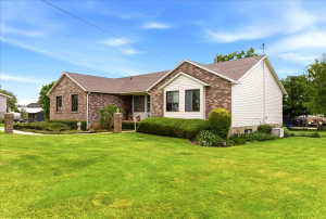 Brick and siding exterior with a gabled roofline