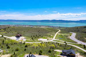 Birds eye view of property featuring a water and mountain view