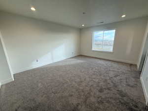 Unfurnished bedroom with carpet flooring and recessed lighting