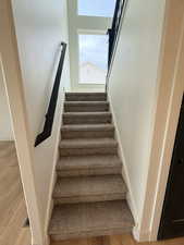 Stairs featuring wood finished floors
