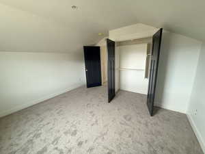 Bonus room featuring lofted ceiling and light colored carpet
