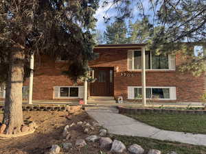 View of front of house with brick siding and entry steps