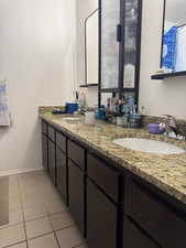 Full bathroom featuring a sink, tile patterned floors, and double vanity