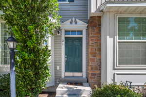 Property entrance featuring board and batten siding