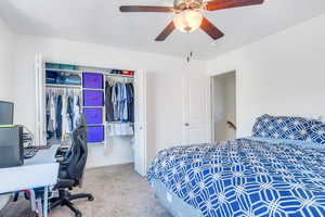 Carpeted bedroom featuring a closet, ceiling fan, and baseboards