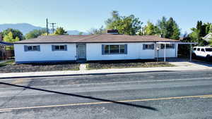 Ranch-style house featuring a mountain view and a chimney