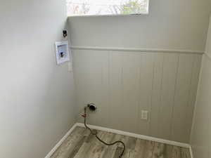 Washroom featuring wood finished floors, laundry area, and washer hookup
