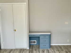 Unfurnished bedroom featuring light wood finished floors, visible vents, and baseboards
