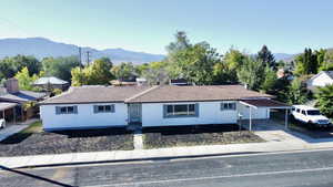 Ranch-style house with a mountain view and concrete driveway