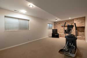 Exercise area with recessed lighting, baseboards, visible vents, and carpet floors