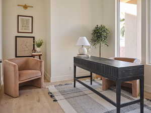 Office space featuring baseboards and wood finished floors