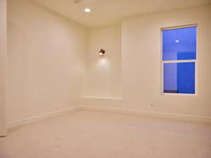 Spare room featuring recessed lighting, carpet flooring, and baseboards