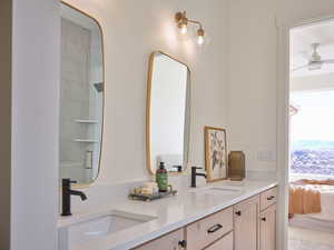 Ensuite bathroom featuring a sink, double vanity, connected bathroom, and a shower with shower door