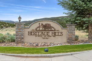 Community sign with a mountain view