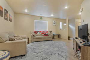 Living area featuring recessed lighting, light wood-type flooring, visible vents, and baseboards