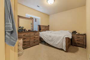 Bedroom featuring carpet floors and visible vents