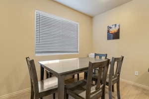 Dining area with baseboards and light wood-style floors