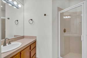 Full bathroom with a shower stall and vanity