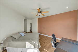 Bedroom with baseboards, light wood-type flooring, recessed lighting, and a ceiling fan