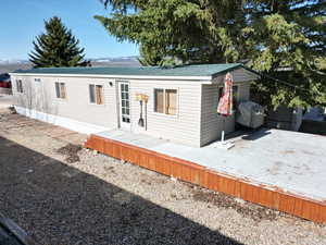 Manufactured / mobile home featuring metal roof and a wooden deck