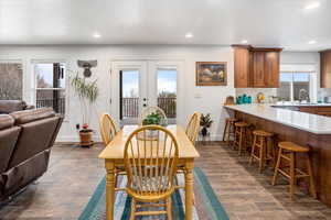 Dining area featuring baseboards, recessed lighting, and dark wood-type flooring