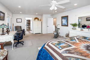Bedroom featuring baseboards, ceiling fan, recessed lighting, a spacious closet, and light colored carpet
