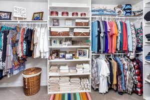 Walk in closet featuring carpet flooring