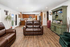 Living area with recessed lighting, baseboards, and dark wood finished floors