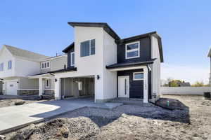 View of front facade with cooling unit, concrete driveway, stucco siding, an attached garage, and fence
