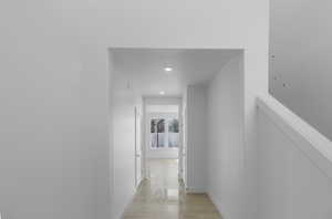 Corridor featuring baseboards, recessed lighting, and light wood finished floors